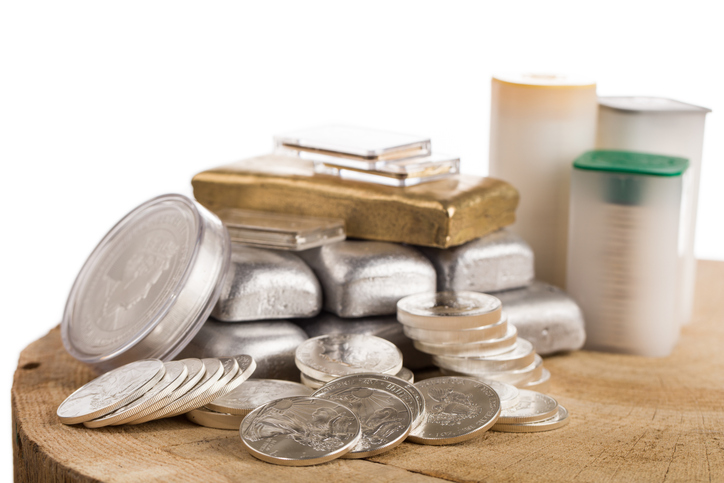 Silver Bullion Bars And Coins On Wooden Table