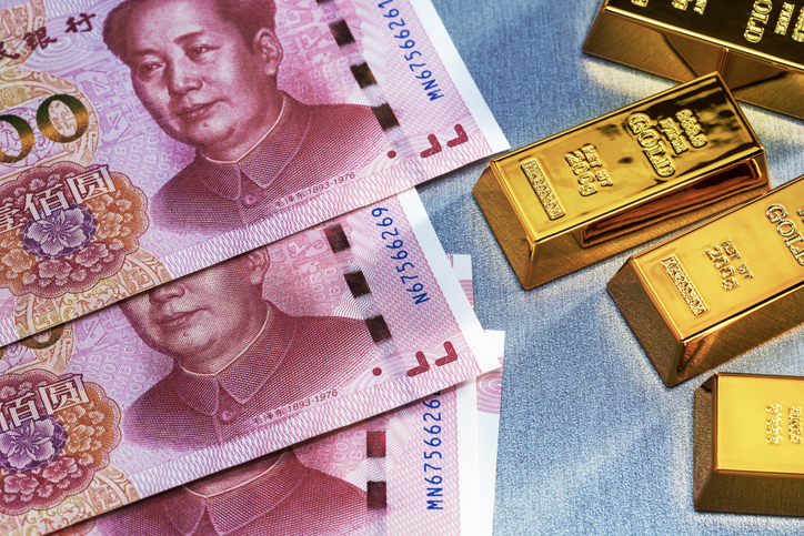 Top View Of Gold Barsâ And Yuan Banknotes. Business Finance Concept.