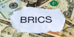 A Dedollarisation Concept With The BRICS On Top Of A Pile Of US Dollar Bills.