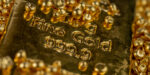 Gold Bar In A Pile Of Gold Granules. Selective Focus.