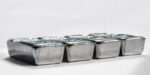 Cast Silver Bullion On A Light Gray Background. Selective Focus.