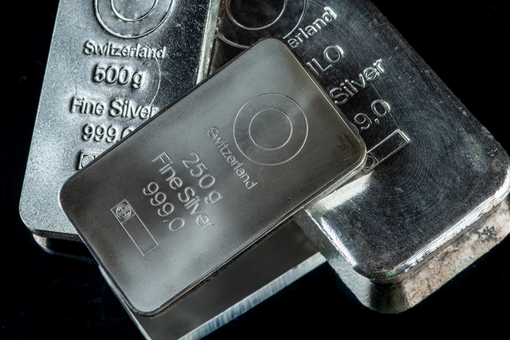 Several Silver Bars Of Different Weights On A Dark Mirror Surface. Selective Focus.
