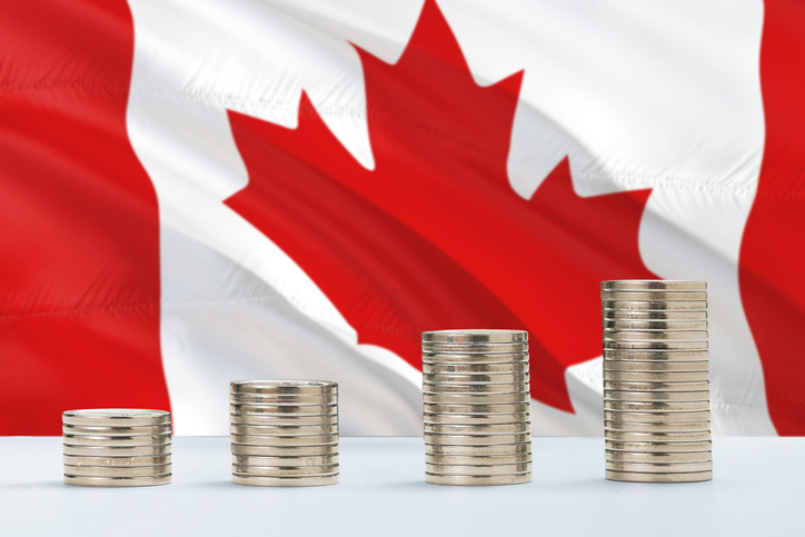 Canada Flag Waving In The Background With Rows Of Coins For Finance And Business Concept. Saving Money.